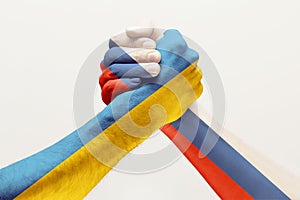 Two hands. Flag of Russian Federation. Flag of Ukraine.