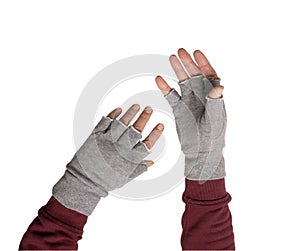 two hands in gray gloves without fingers