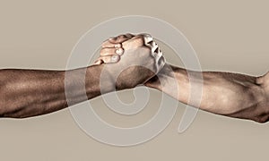 Two hands, helping arm of a friend, teamwork. Friendly handshake, friends greeting, teamwork