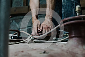 Two hands hold round flange on metal structure