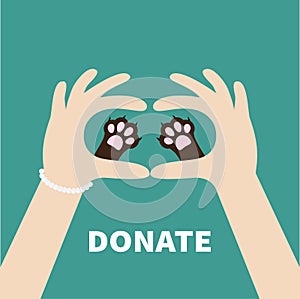 Two hands holding cute cat dog paw print. Love and care pet animals. Helping hand concept. Donate text. Flat design. Green