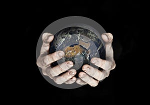 Two hands holding planet Earth isolated on black. Elements of this image furnished by NASA.