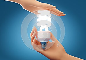 Two hands holding and protecting energy saving light bulb over blue background. Concept of energy saving, ecology