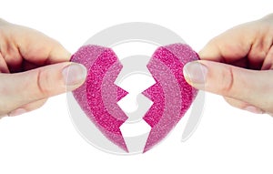 Two hands holding two halves broken pink heart into two parts together isolated on white background, romantic,dating