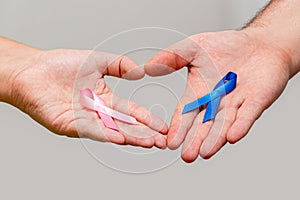 Two hands holding two Pink and Blue ribbons for the Pink October and Blue November campaigns to support life and raise awareness