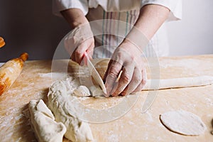 Two hands making dough for meat dumplings.