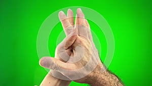 two hands male and female on green background chromakey meet crossed fingers smooth and squeezing love concept of