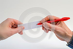 Two hands, one holding a red marker, marking a vote on a ballot paper. The background is plain white, focusing solely on