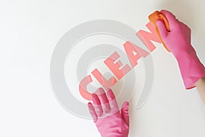 Two hands in pink gloves cleaning the solid color surface, clean service text creative idea d