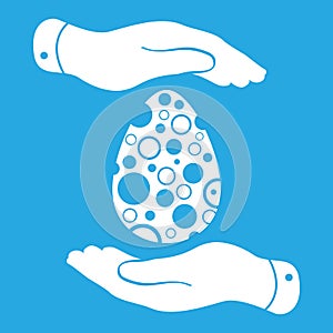 Two hands protecting white easter traditional egg icon on a blue