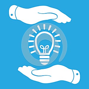 Two hands protecting white idea light lamp bulb icon on a blue b