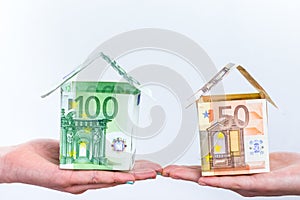 Two hands showing euro bills houses
