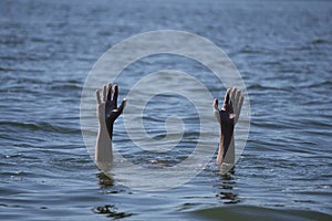 Two Hands stick out of water danger