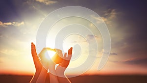 Two hands on sunsut.