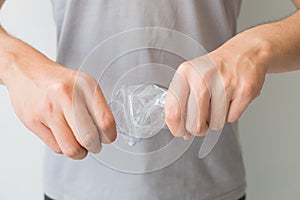 Two hands twisting clear plastic bottle on isolated white background and including clipping path, Resize plastic bottle before