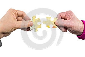 Two hands uniting fitting puzzle pieces