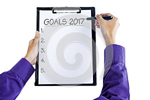 Two hands writing business goals 2017