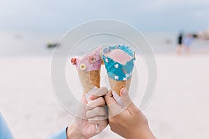 Two hands young teen women holding ice cream cone on summer in beach and sea.
