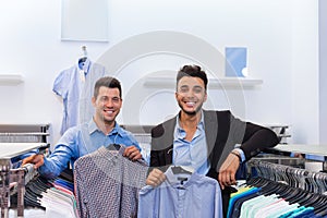 Two Handsome Business Man Fashion Shop, Happy Smiling Mix Race Friends Customers Choosing Clothes Shirts In Retail Store