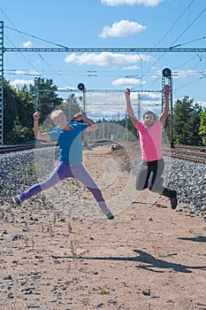 Two handsome young guys jumping