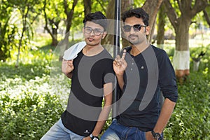 Two handsome young men in casual trendy clothes looking at camera