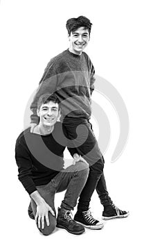 Two handsome young men posing on a white background