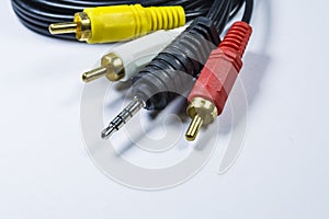 Two hanks of cables with multi-colored plugs a tulip. Black cord. White monophonic background.