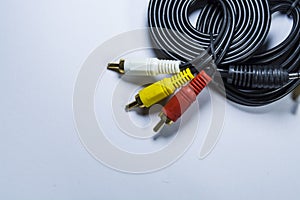 Two hanks of cables with multi-colored plugs a tulip. Black cord. White monophonic background.