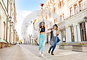 Two happily jumping girls while walking