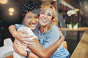Two happy affectionate young woman hugging photo