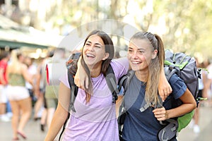 Two happy backpackers laughing enjoying vacation photo