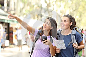 Two backpackers sightseeing pointing at landmark photo