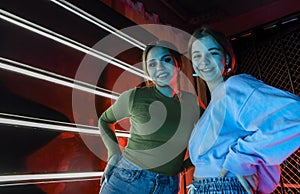 Two happy best female friends young girls at disco party posing for photo