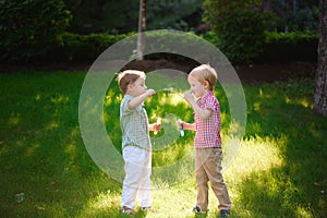 two happy boy play in bubbles outdoors
