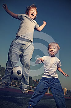 Two happy boy play in soccer