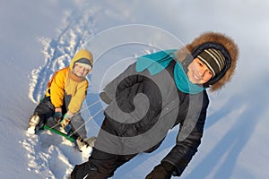 Two happy boys on sled