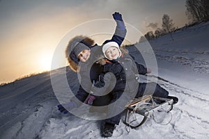 Two happy boys on sled