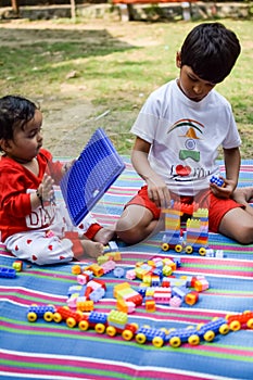 Two happy boys in society park, happy Asian brothers who are smiling happily together. Brothers play outdoors in summer, best