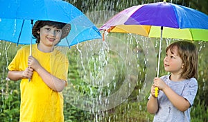 two happy brother with umbrella summer outdoors