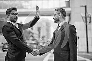 two happy business partners dealing. two business partners dealing with handshake.