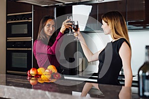 Two happy business partners raising glasses of wine proposing a toast for a successful mutual cooperation