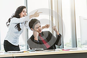 Two happy business people celebrate at office