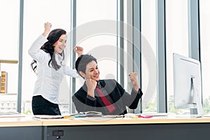 Two happy business people celebrate at office