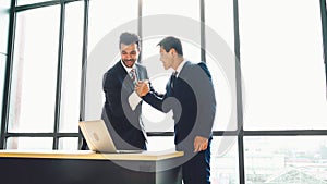 Two happy business people celebrate at office