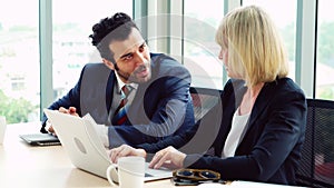 Two happy business people celebrate at office