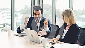 Two happy business people celebrate at office