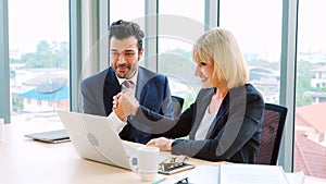 Two happy business people celebrate at office