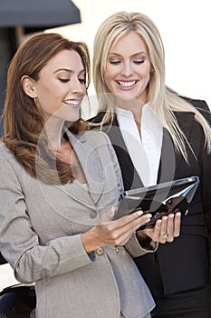 Two Happy Businesswomen Using a Tablet Computer