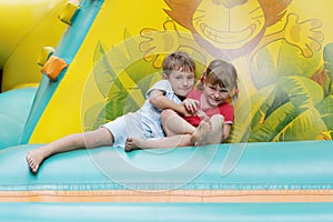 Two happy children having fun on trampoline