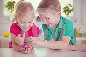 Two happy children playing with dices